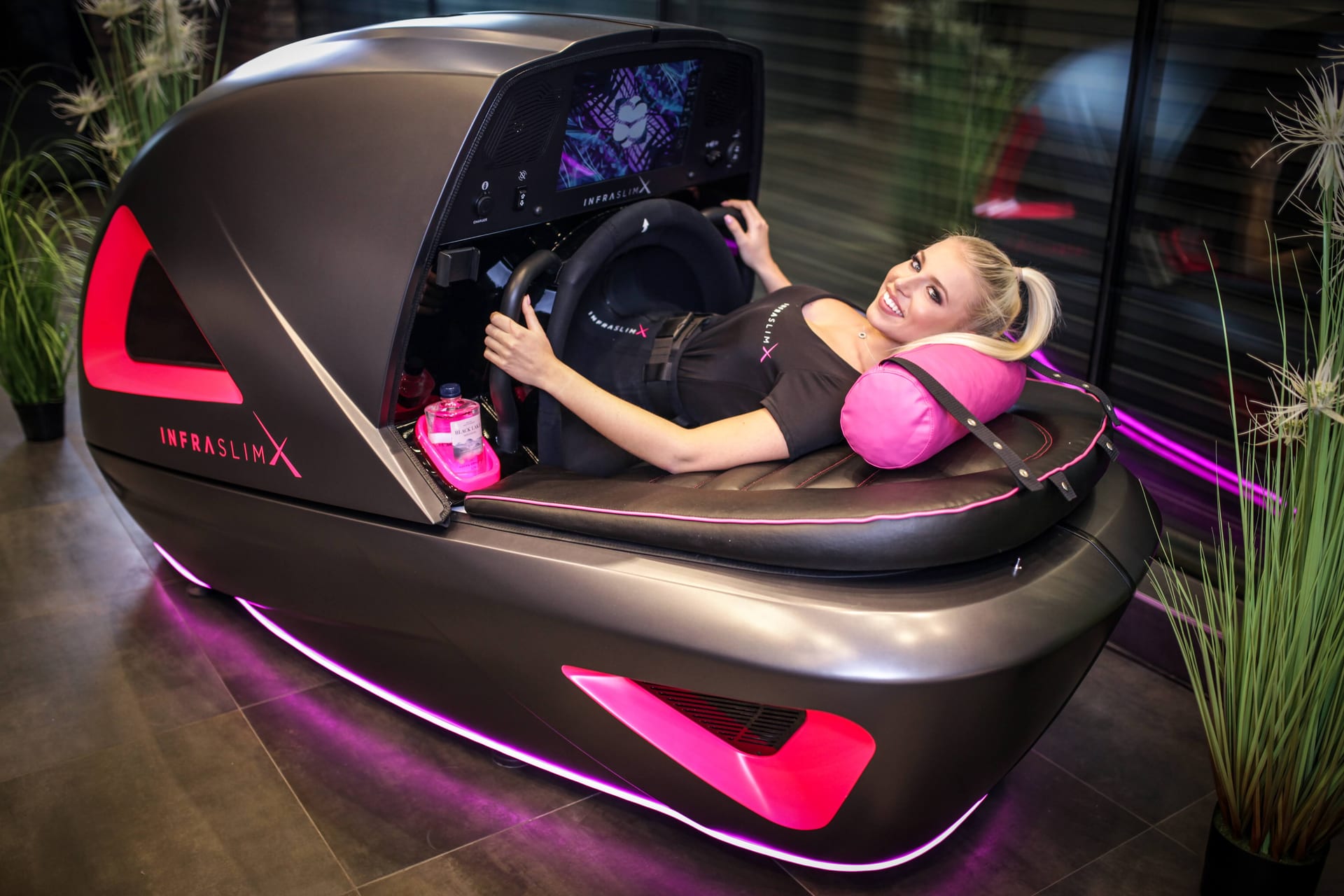 Client relaxing during InfraSlimX session with pink pillow